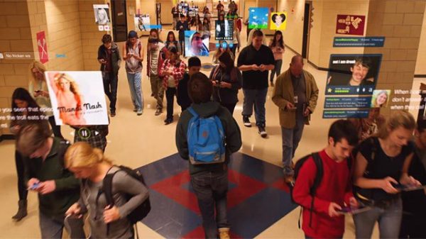 A sea of faces absorbed in screens